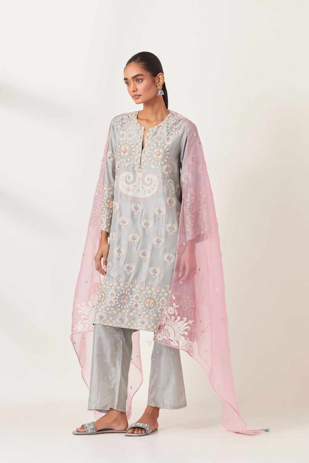 Blue silk straight hem mid-length abha style kurta set with bold appliqué embroidery along with multi-colored aari thread work and tassels.