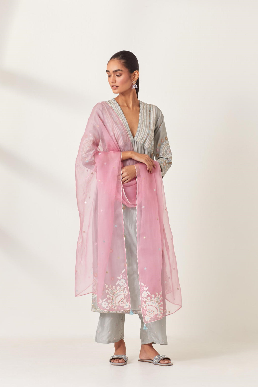 Pink silk organza dupatta with appliqué work and multi colored flower embroidery all-over the dupatta.