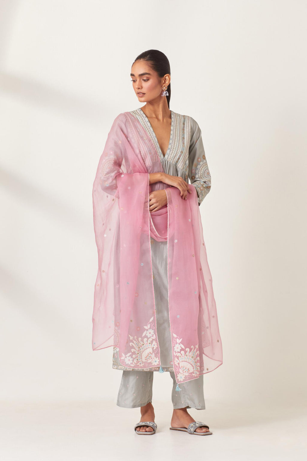 Pink silk organza dupatta with appliqué work and multi colored flower embroidery all-over the dupatta.