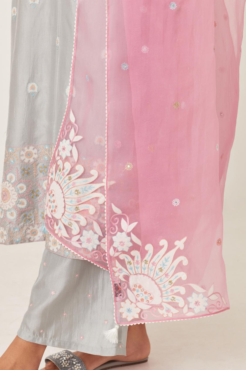 Blue silk kurta set with multi-colored bold appliqué, bootas at borders and aari threadwork, highlighted with sequins.