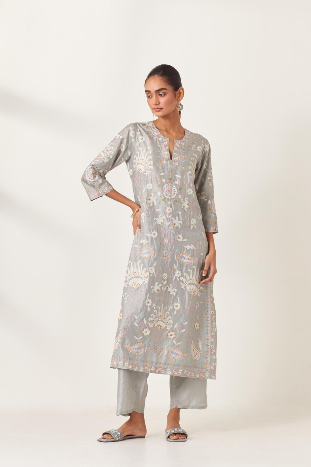Blue straight kurta set, fully embroidered with bold appliqué flowers, multi-colored aari threadwork and silk tassels.