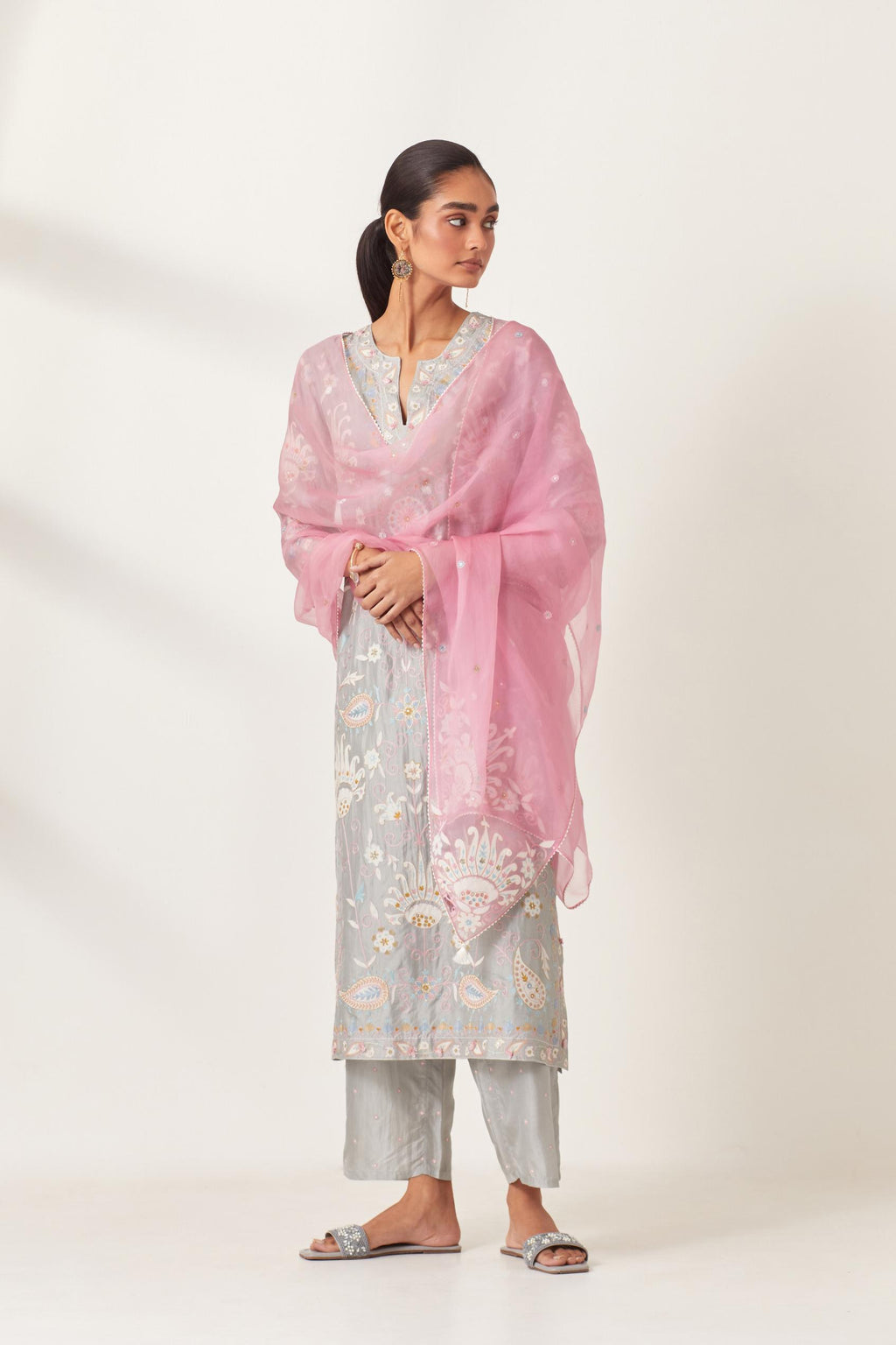 Pink silk organza dupatta with appliqué work and multi colored flower embroidery all-over the dupatta.