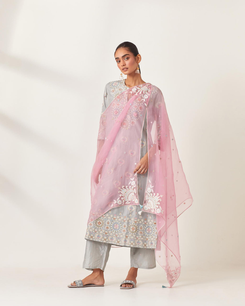 Pink silk organza dupatta with appliqué work and multi colored flower embroidery all-over the dupatta.