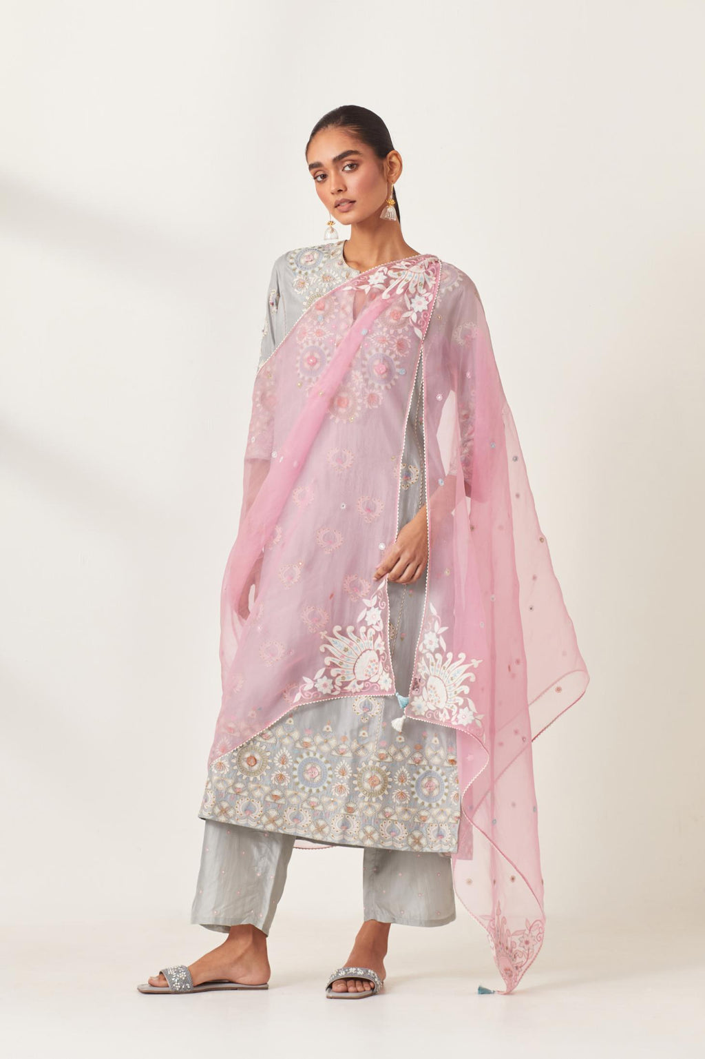 Pink silk organza dupatta with appliqué work and multi colored flower embroidery all-over the dupatta.