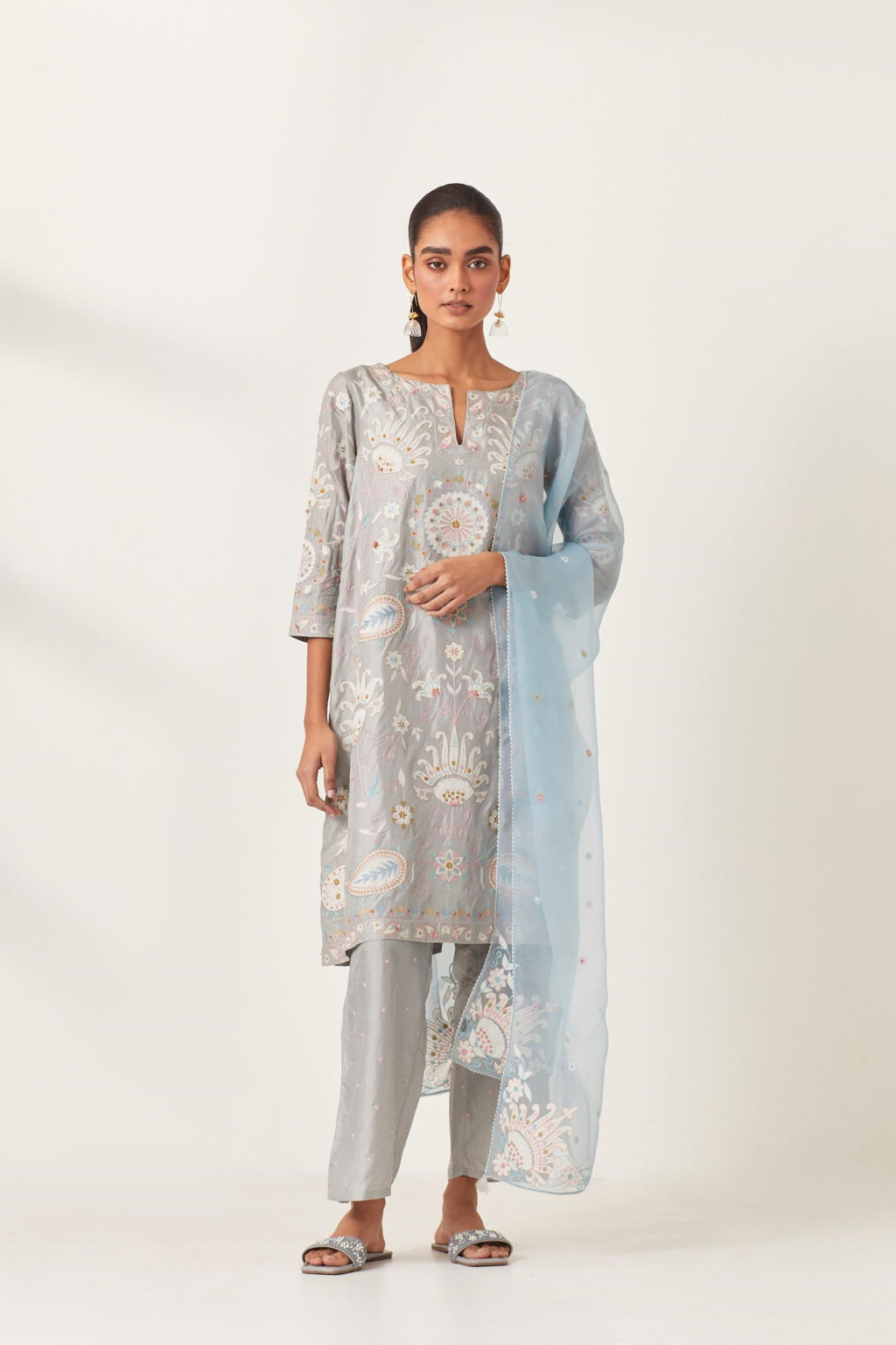 Blue short A-line silk kurta set, fully embroidered with multi colored appliqué with aari thread work and silk tassels.