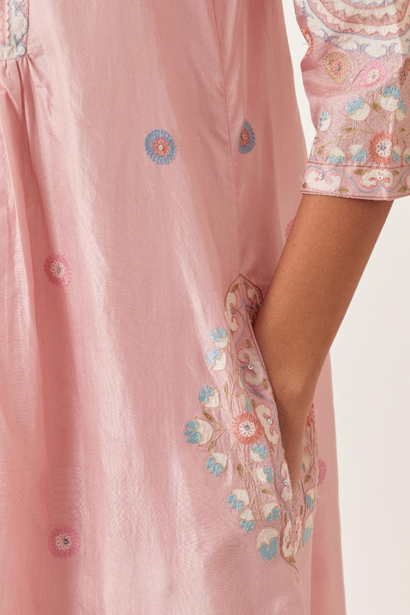 Pink silk gathered kurta-dress set with appliqué stripes along with aari threadwork flowers and floral trellises along with a circular appliqued motif.
