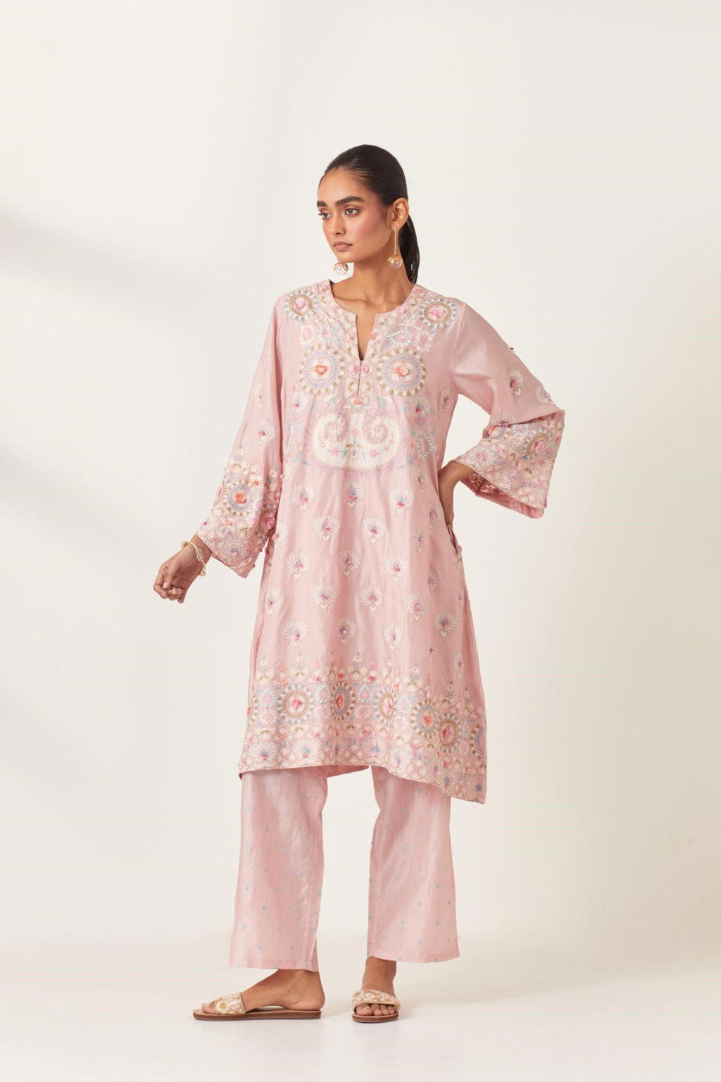 Pink silk straight hem mid-length abha style kurta set with bold appliqué embroidery along with multi-colored aari thread work and tassels.