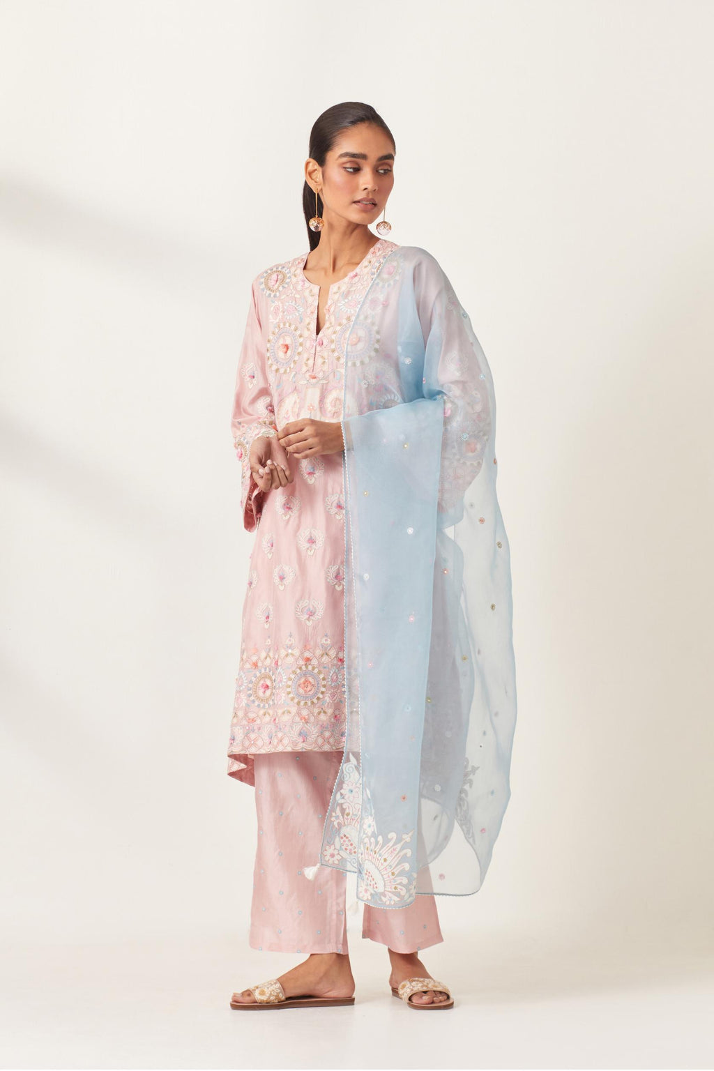 Pink silk straight hem mid-length abha style kurta set with bold appliqué embroidery along with multi-colored aari thread work and tassels.