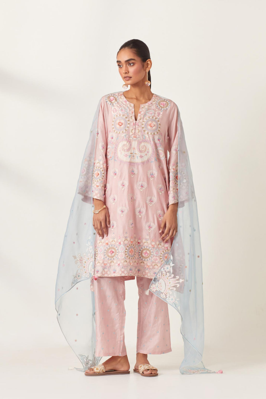 Pink silk straight hem mid-length abha style kurta set with bold appliqué embroidery along with multi-colored aari thread work and tassels.