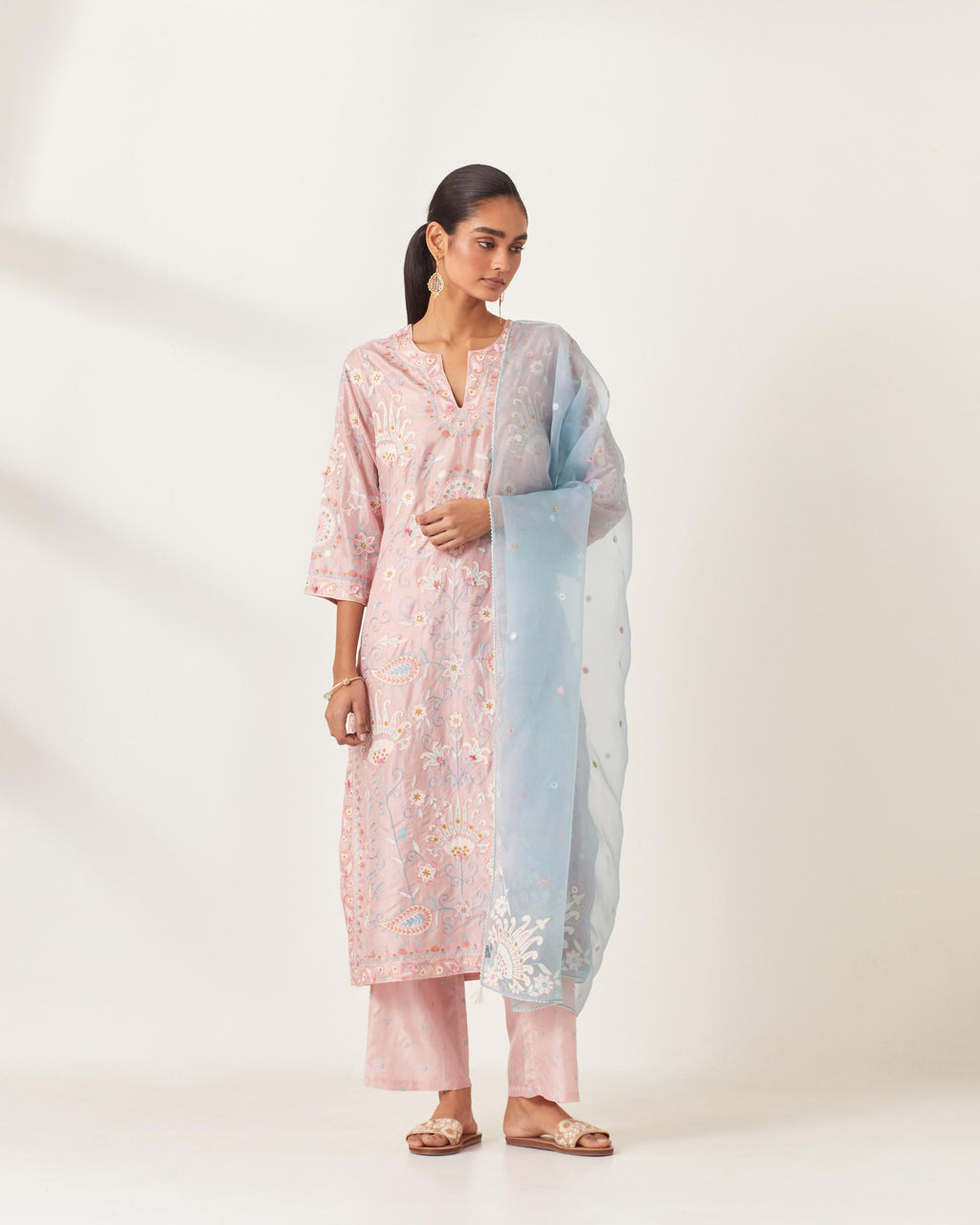 Pink straight kurta set, fully embroidered with bold appliqué flowers, multi-colored aari threadwork and silk tassels.