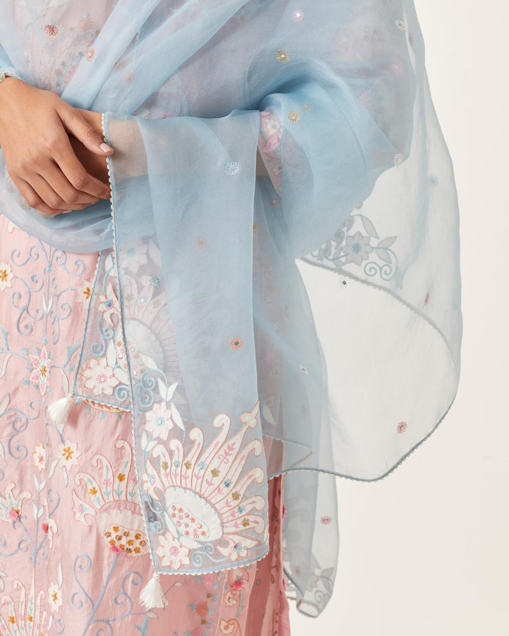 Blue silk organza dupatta with appliqué work and multi colored flower embroidery all-over the dupatta.