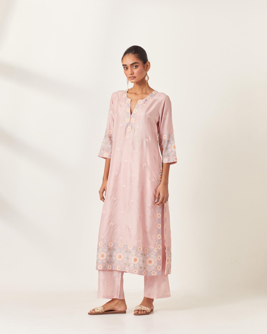 Pink silk kurta set with multi-colored bold appliqué, bootas at borders and aari threadwork, highlighted with sequins.