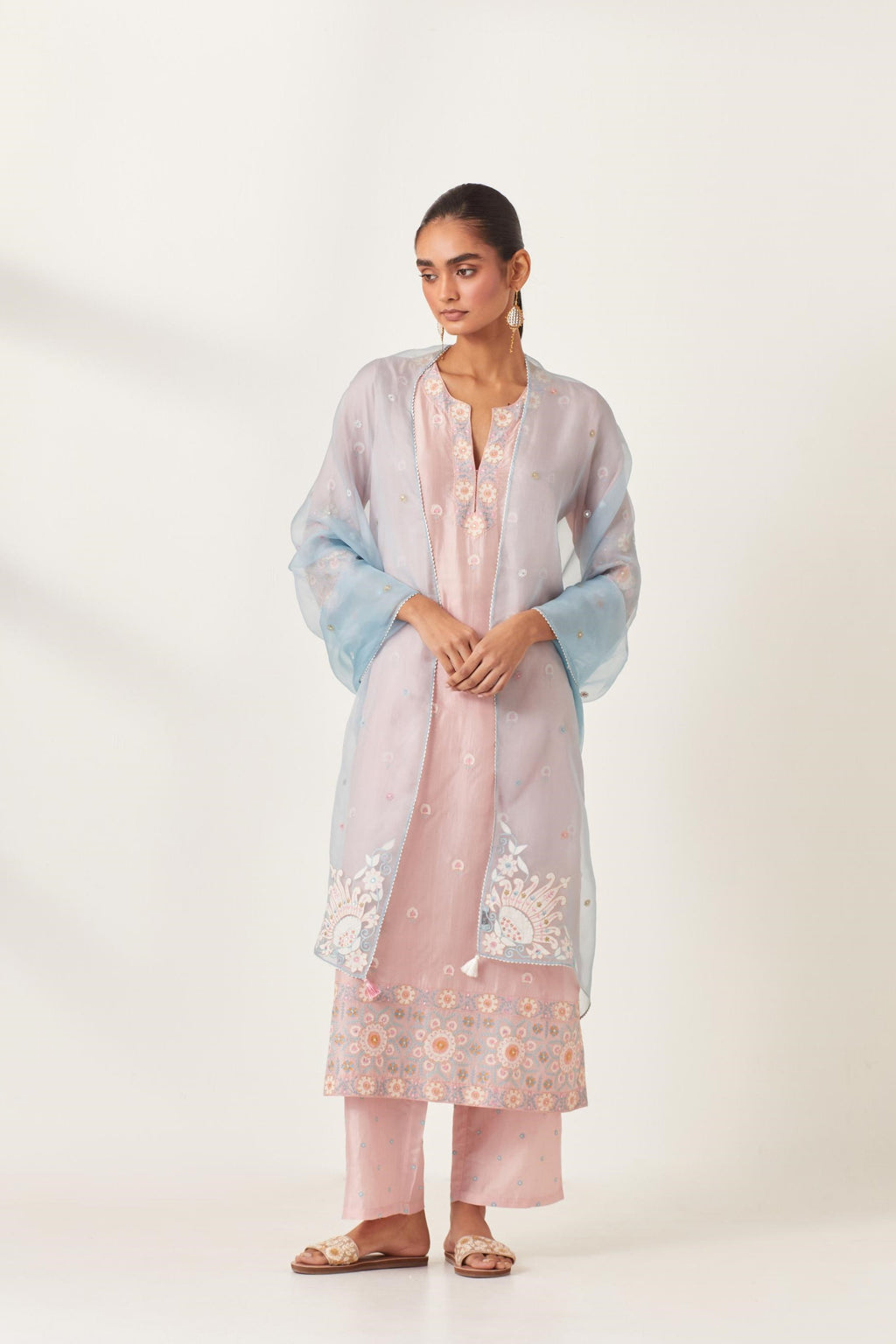 Pink silk kurta set with multi-colored bold appliqué, bootas at borders and aari threadwork, highlighted with sequins.