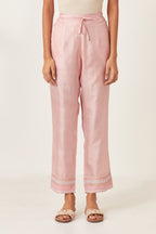 Pink silk straight pants detailed with quilted multi colored embroidery at bottom.