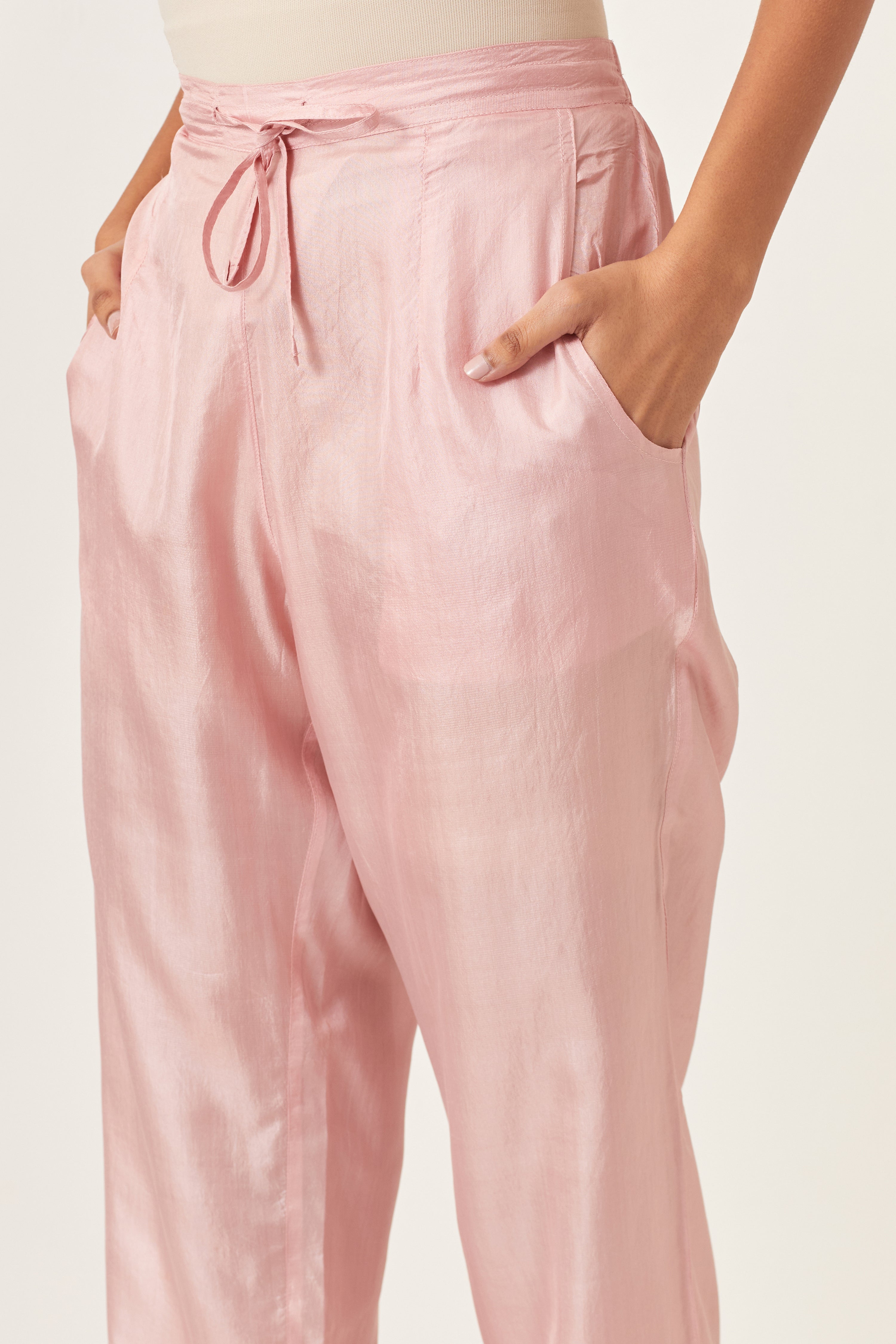 Pink silk straight pants detailed with quilted multi colored embroidery at bottom.