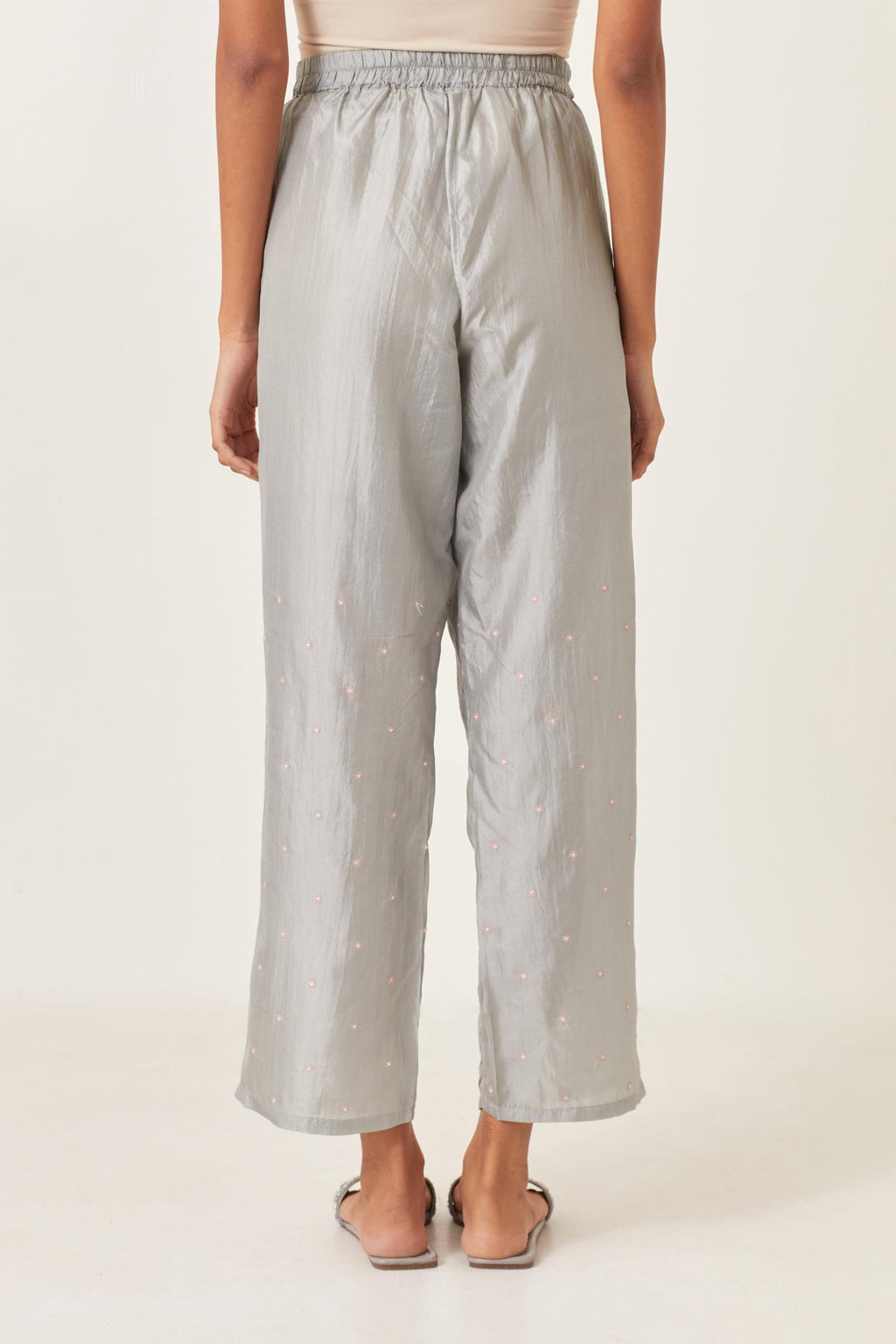 Blue silk straight pants detailed with small flower embroidery at bottom.