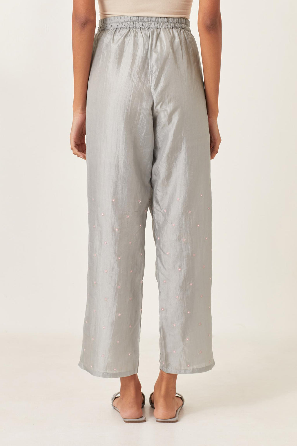 Blue silk straight pants detailed with small flower embroidery at bottom.