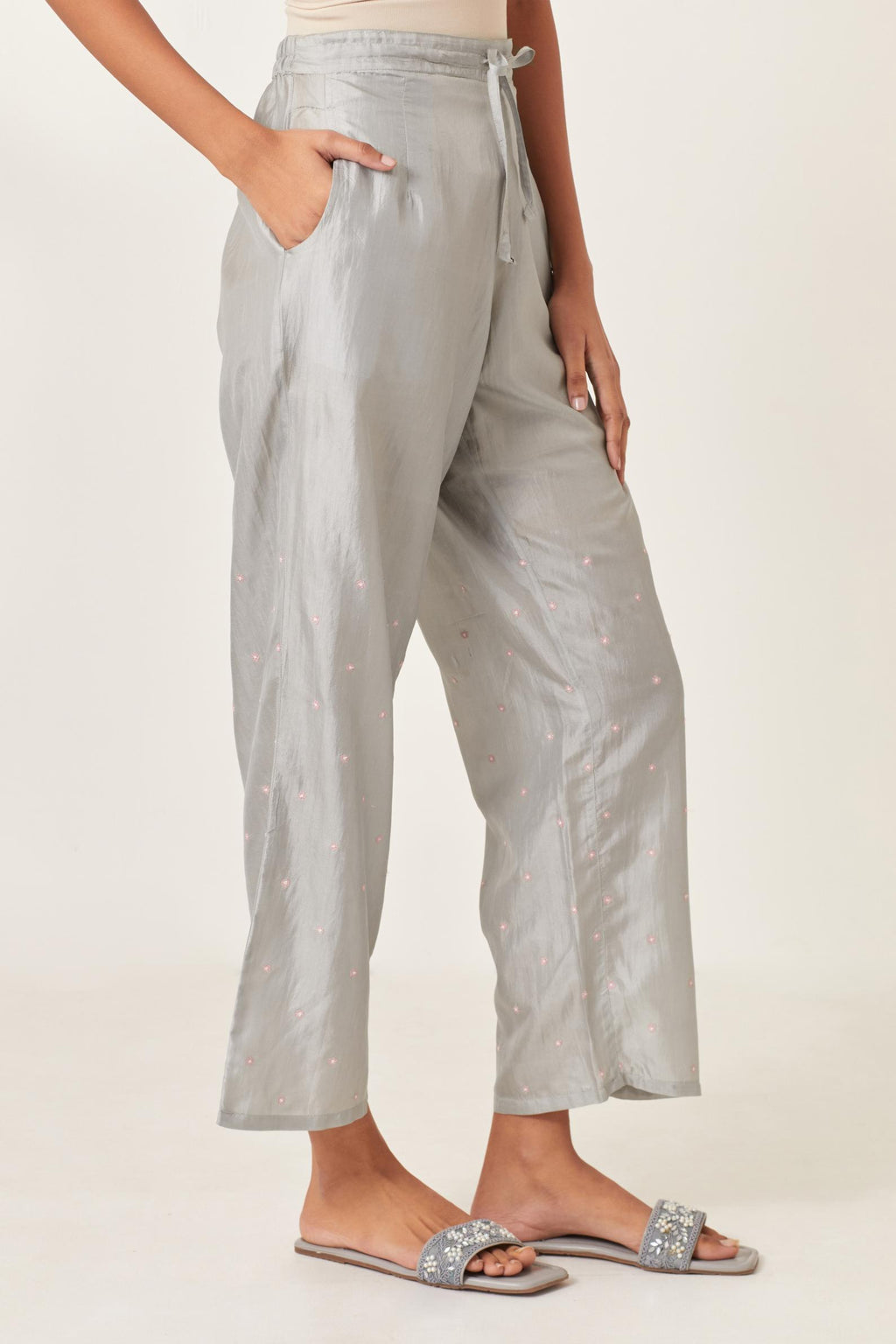 Blue silk straight pants detailed with small flower embroidery at bottom.