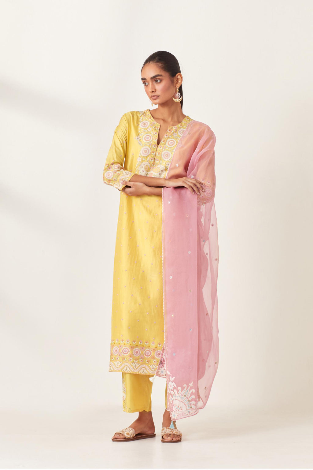 Yellow slim fit straight kurta set, decorated with bold appliqué borders all along the side seam, hem and sleeve cuffs.