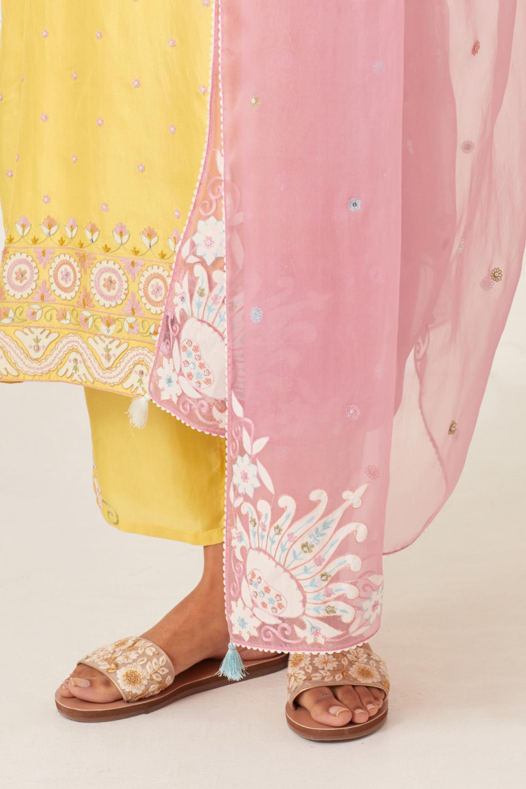 Yellow slim fit straight kurta set, decorated with bold appliqué borders all along the side seam, hem and sleeve cuffs.