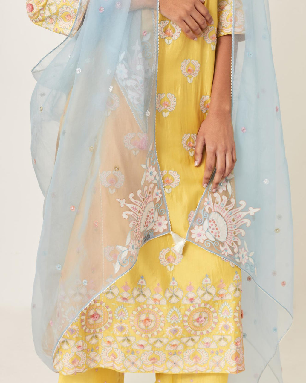 Blue silk organza dupatta with appliqué work and multi colored flower embroidery all-over the dupatta.