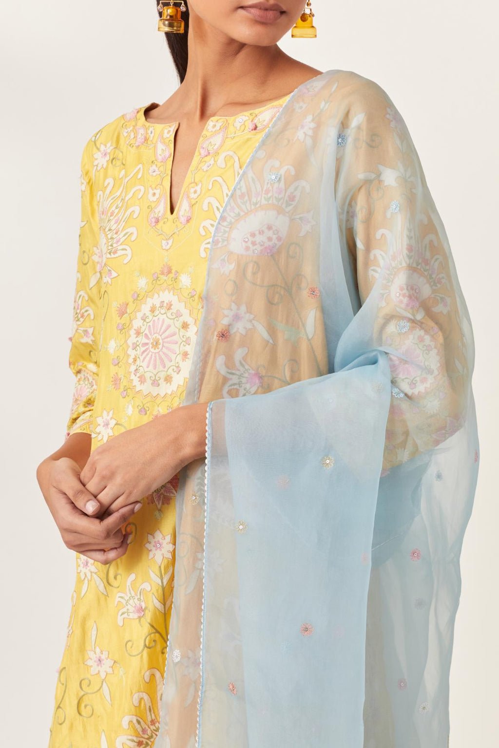 Yellow short A-line silk kurta set, fully embroidered with multi colored appliqué with aari thread work and silk tassels.