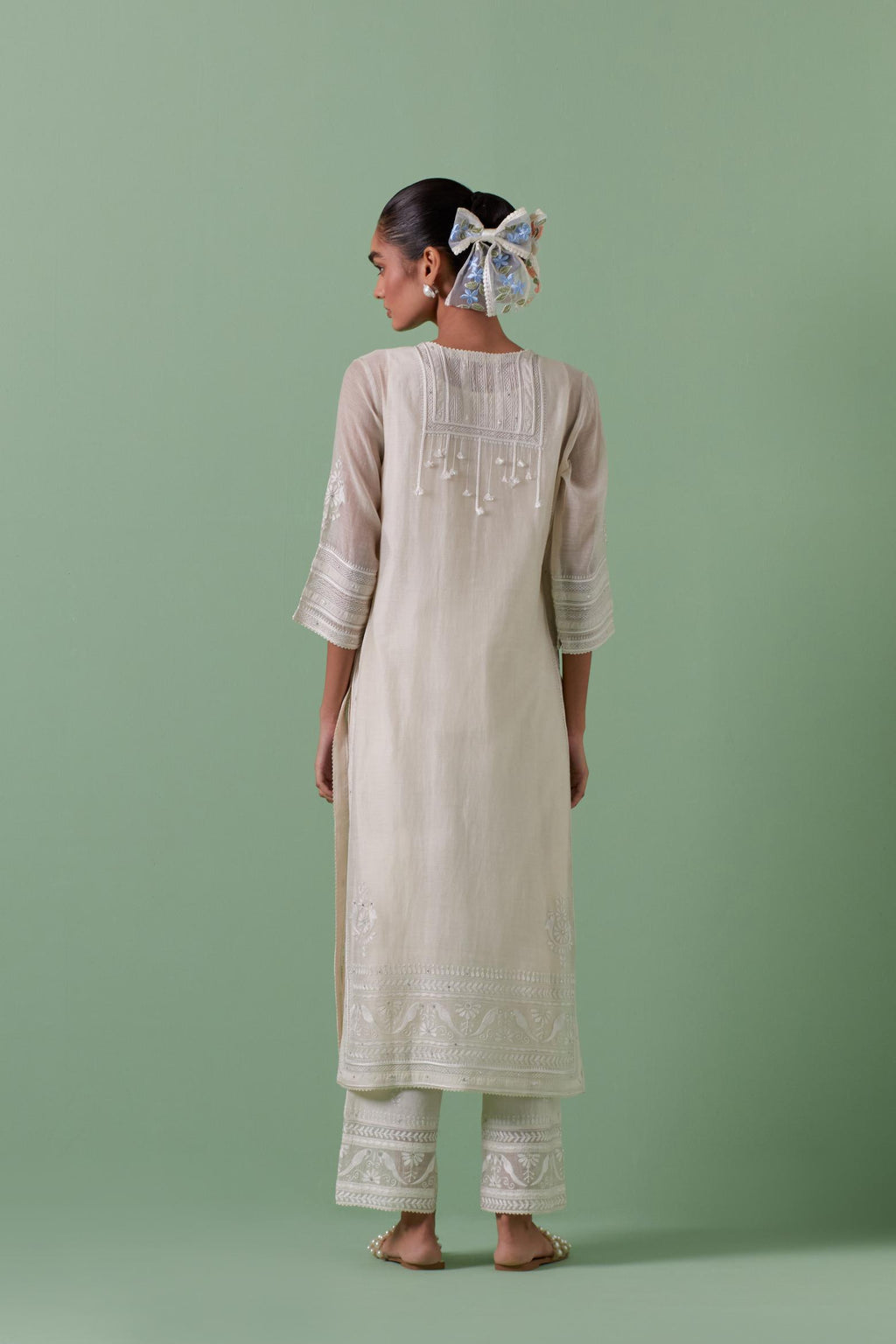 Off-white cotton chanderi straight kurta set with yoke with patchwork and silk thread embroidery highlighted with mirror, sequins, tassels and braids.