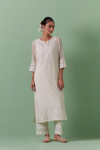 Off-white cotton chanderi straight kurta set with yoke with patchwork and silk thread embroidery highlighted with mirror, sequins, tassels and braids.
