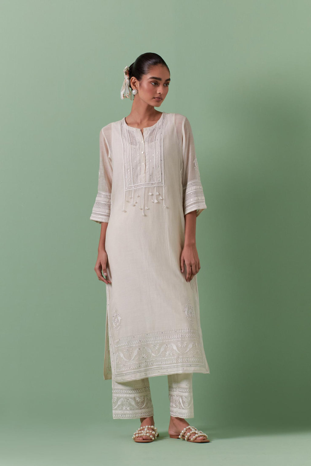 Off-white cotton chanderi straight kurta set with yoke with patchwork and silk thread embroidery highlighted with mirror, sequins, tassels and braids.