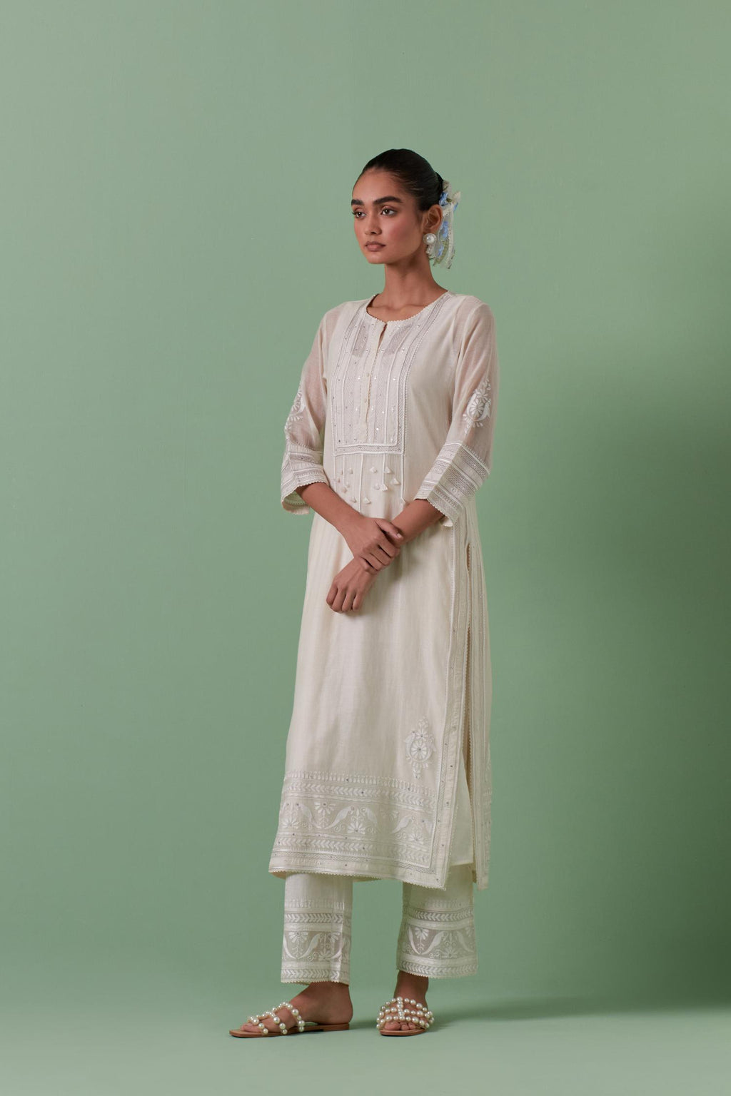 Off-white cotton chanderi straight kurta set with yoke with patchwork and silk thread embroidery highlighted with mirror, sequins, tassels and braids.