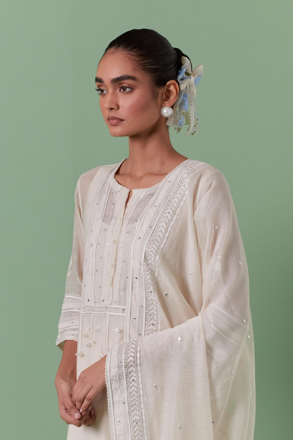 Off-white cotton chanderi straight kurta set with yoke with patchwork and silk thread embroidery highlighted with mirror, sequins, tassels and braids.
