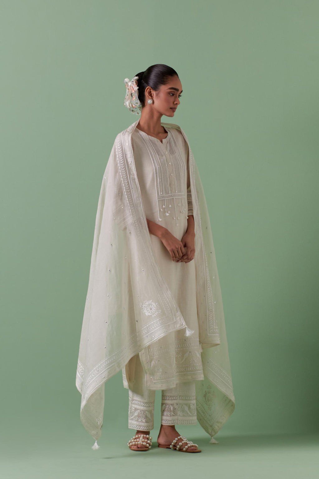 Off-white cotton chanderi straight kurta set with yoke with patchwork and silk thread embroidery highlighted with mirror, sequins, tassels and braids.