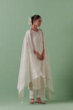 Off-white cotton chanderi straight kurta set with yoke with patchwork and silk thread embroidery highlighted with mirror, sequins, tassels and braids.