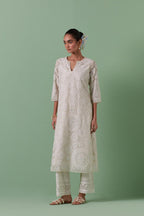Off-white cotton chanderi straight kurta set with all over patchwork, silk thread, mirror, tassels embroidery and sequins.