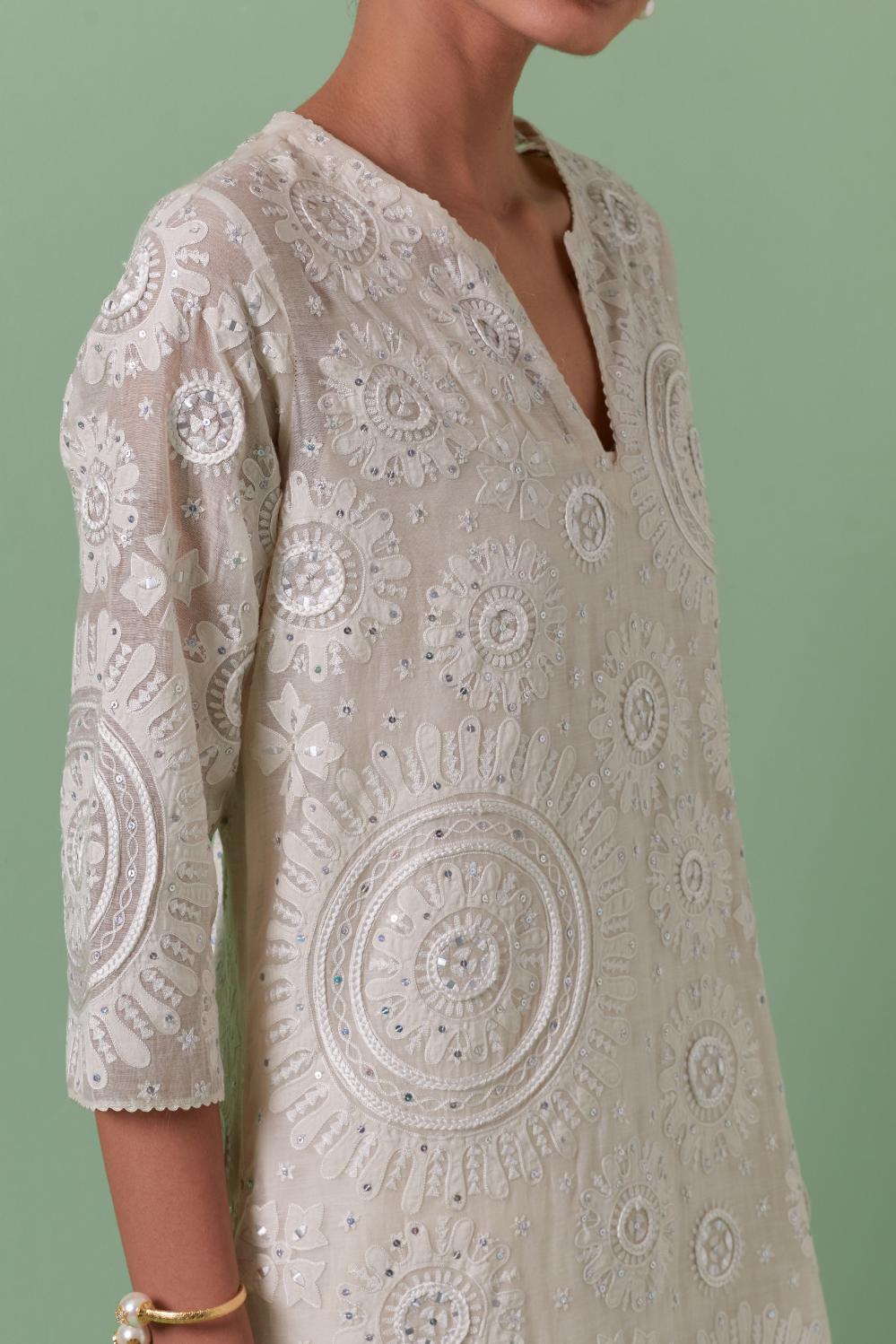 Off-white cotton chanderi straight kurta set with all over patchwork, silk thread, mirror, tassels embroidery and sequins.