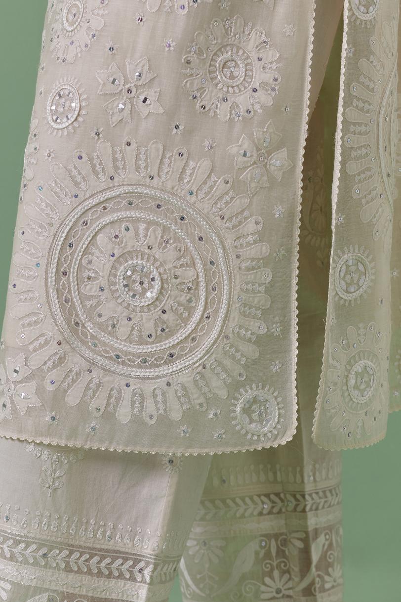 Off-white cotton chanderi straight kurta set with all over patchwork, silk thread, mirror, tassels embroidery and sequins.