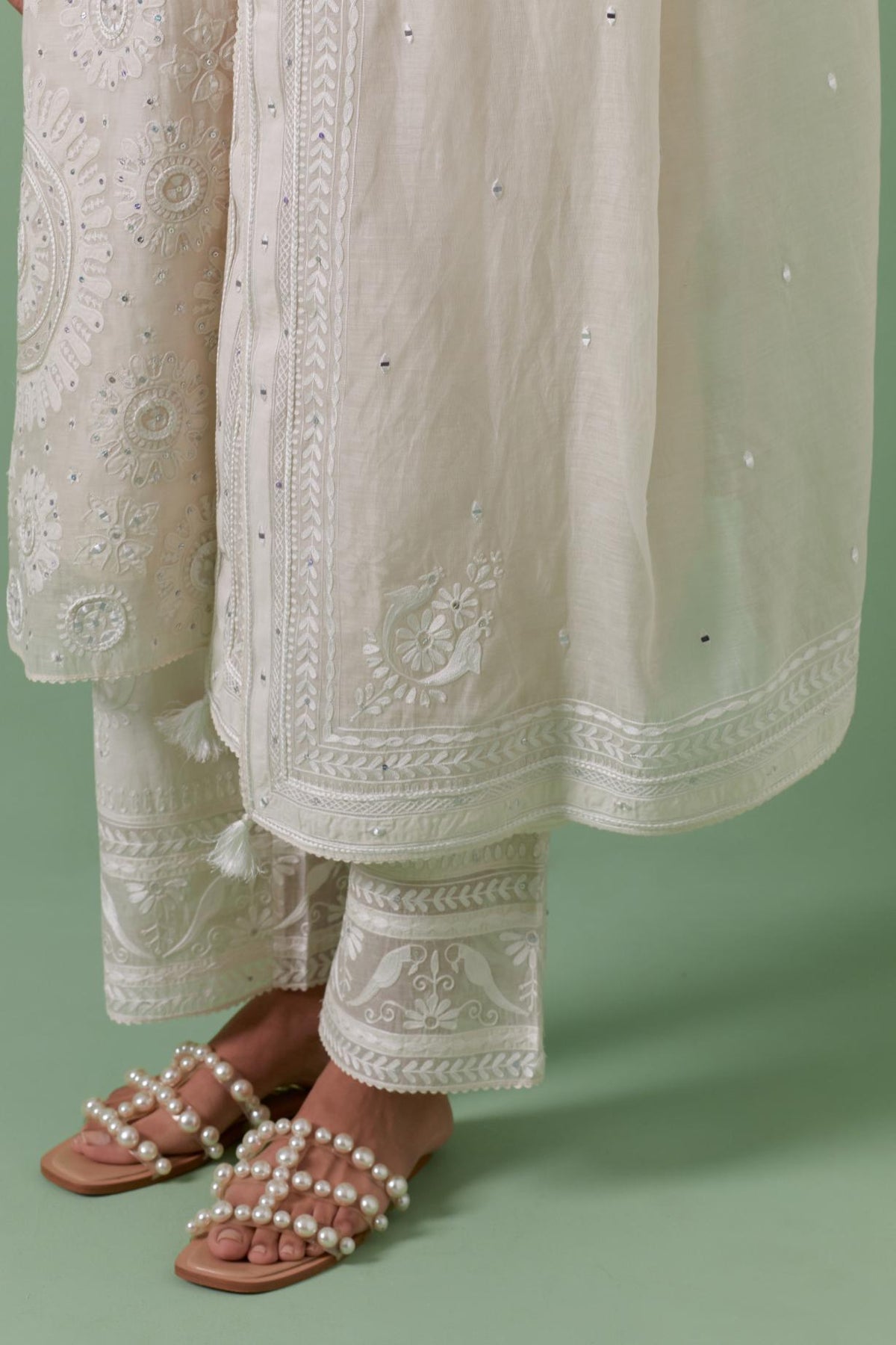 Off-white cotton chanderi dupatta with delicate silk thread embroidery, highlighted with braids, mirrors and sequins.