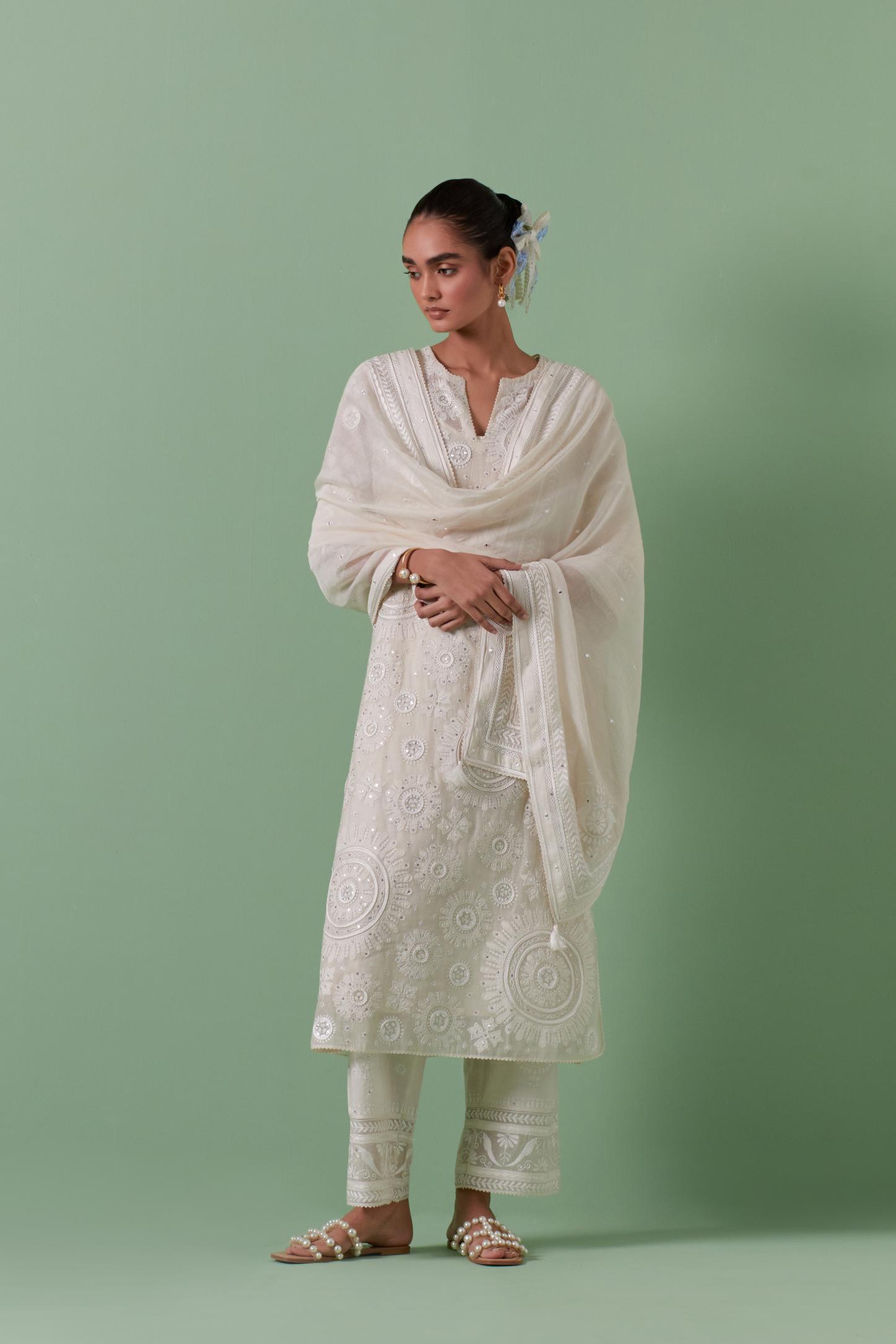Off-white cotton chanderi straight kurta set with all over patchwork, silk thread, mirror, tassels embroidery and sequins.