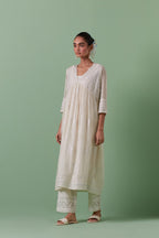 Off-white cotton chanderi embroidered kurta set dress with V neck, yoke and fine gathers at empire line.