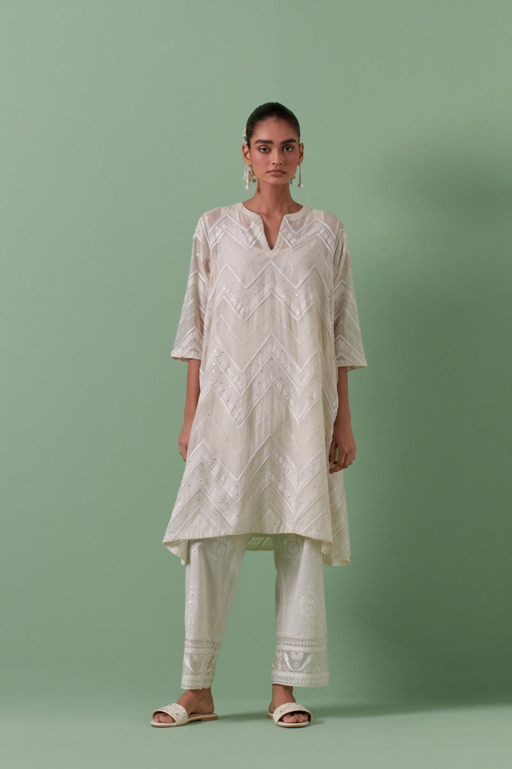 Off-white cotton chanderi A-line kurta set with all over embroidery set in bold chevron stripes.