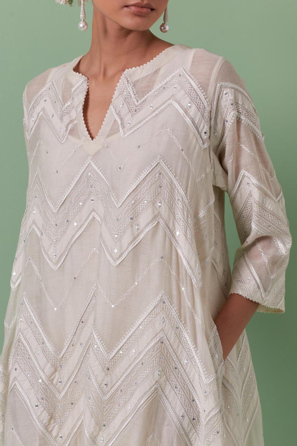 Off-white cotton chanderi A-line kurta set with all over embroidery set in bold chevron stripes.