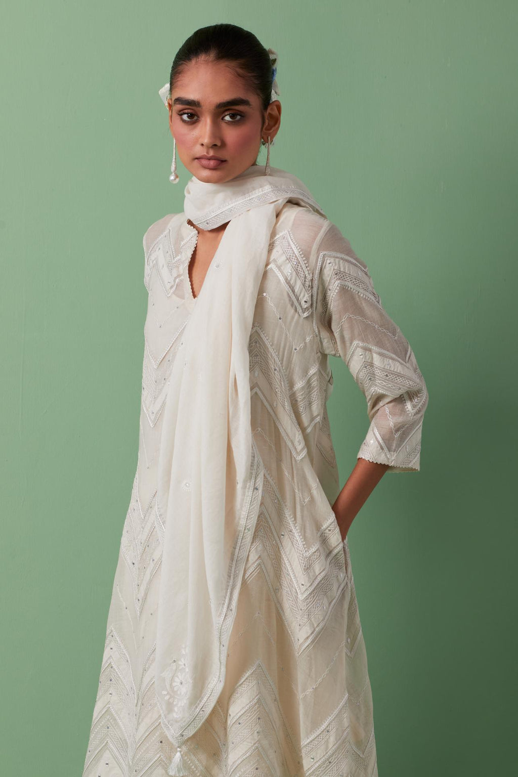 Off-white cotton chanderi A-line kurta set with all over embroidery set in bold chevron stripes.