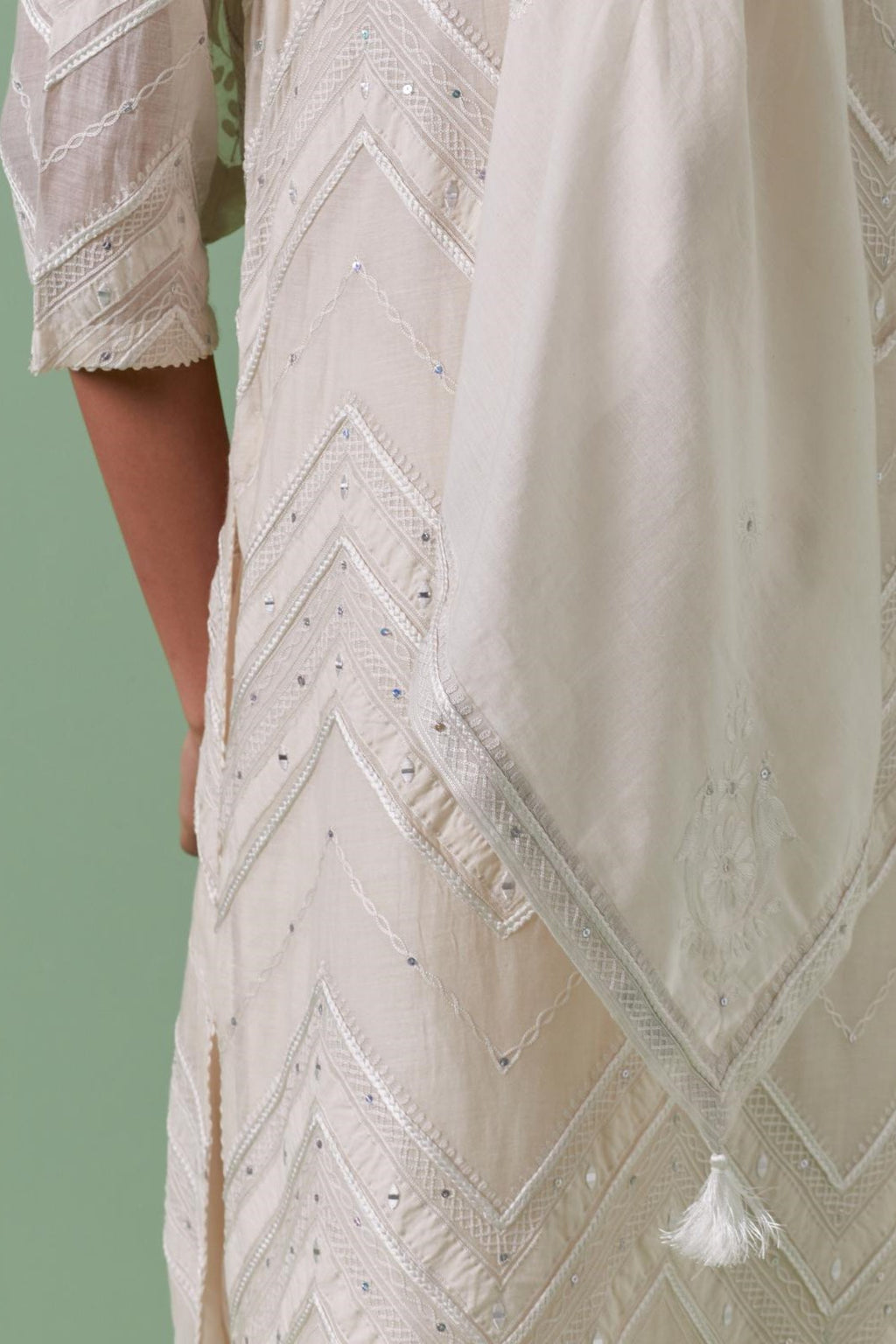 Off-white cotton square scarf with delicate silk thread embroidery, highlighted with braids, mirrors and sequins.