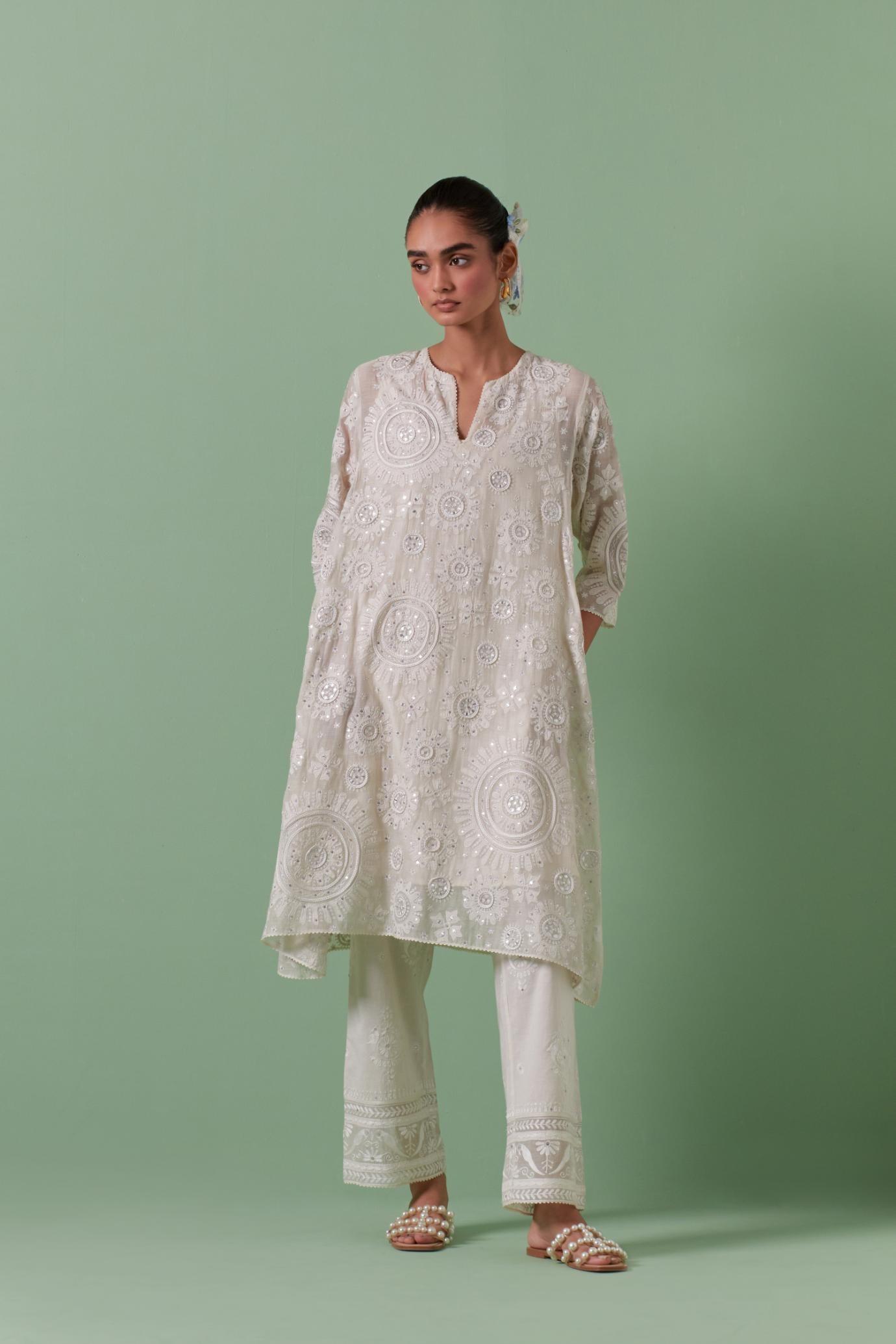 Off-white A-line cotton chanderi kurta set with all over patchwork, silk thread, mirror, tassels embroidery and sequins.