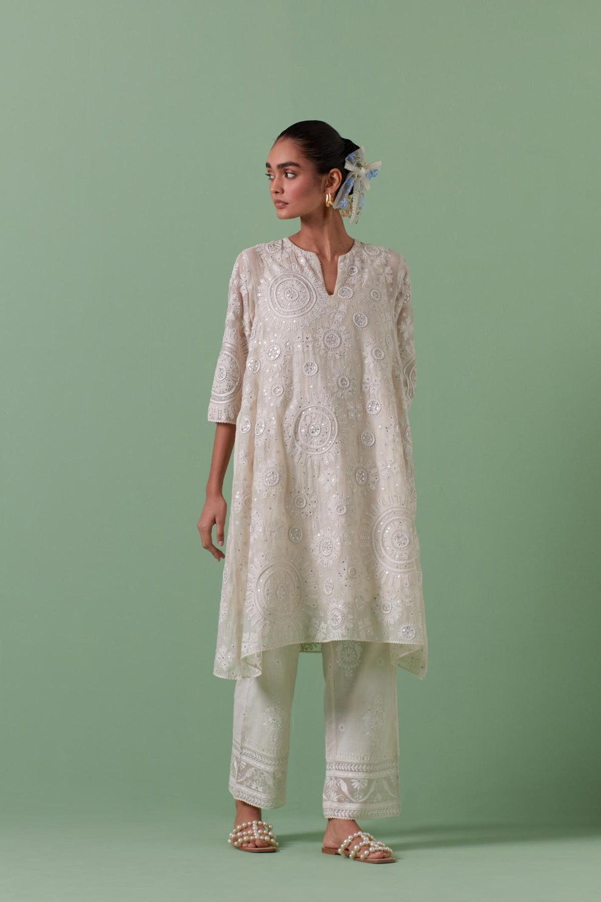 Off-white A-line cotton chanderi kurta set with all over patchwork, silk thread, mirror, tassels embroidery and sequins.