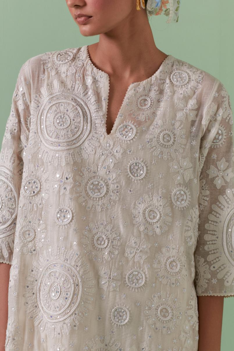 Off-white A-line cotton chanderi kurta set with all over patchwork, silk thread, mirror, tassels embroidery and sequins.
