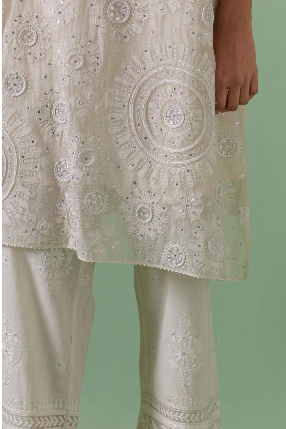 Off-white A-line cotton chanderi kurta set with all over patchwork, silk thread, mirror, tassels embroidery and sequins.