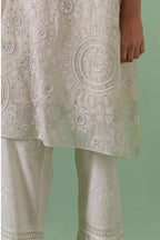 Off-white A-line cotton chanderi kurta set with all over patchwork, silk thread, mirror, tassels embroidery and sequins.