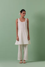 Off-white A-line cotton chanderi kurta set with all over patchwork, silk thread, mirror, tassels embroidery and sequins.