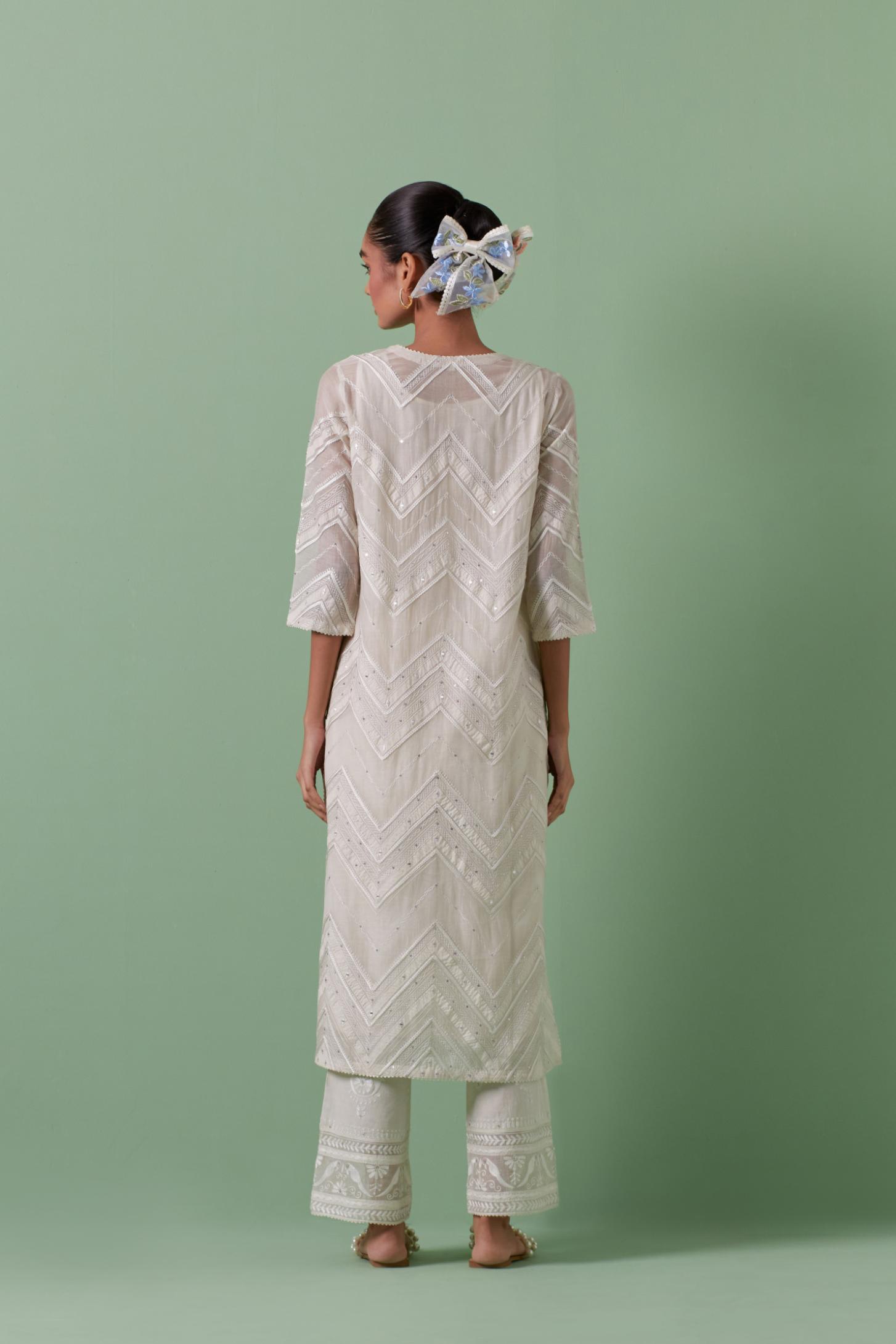 Off-white cotton chanderi straight kurta set with all over chevron pattern. It is embellished with silk patchwork, thread, sequins and mirrors.